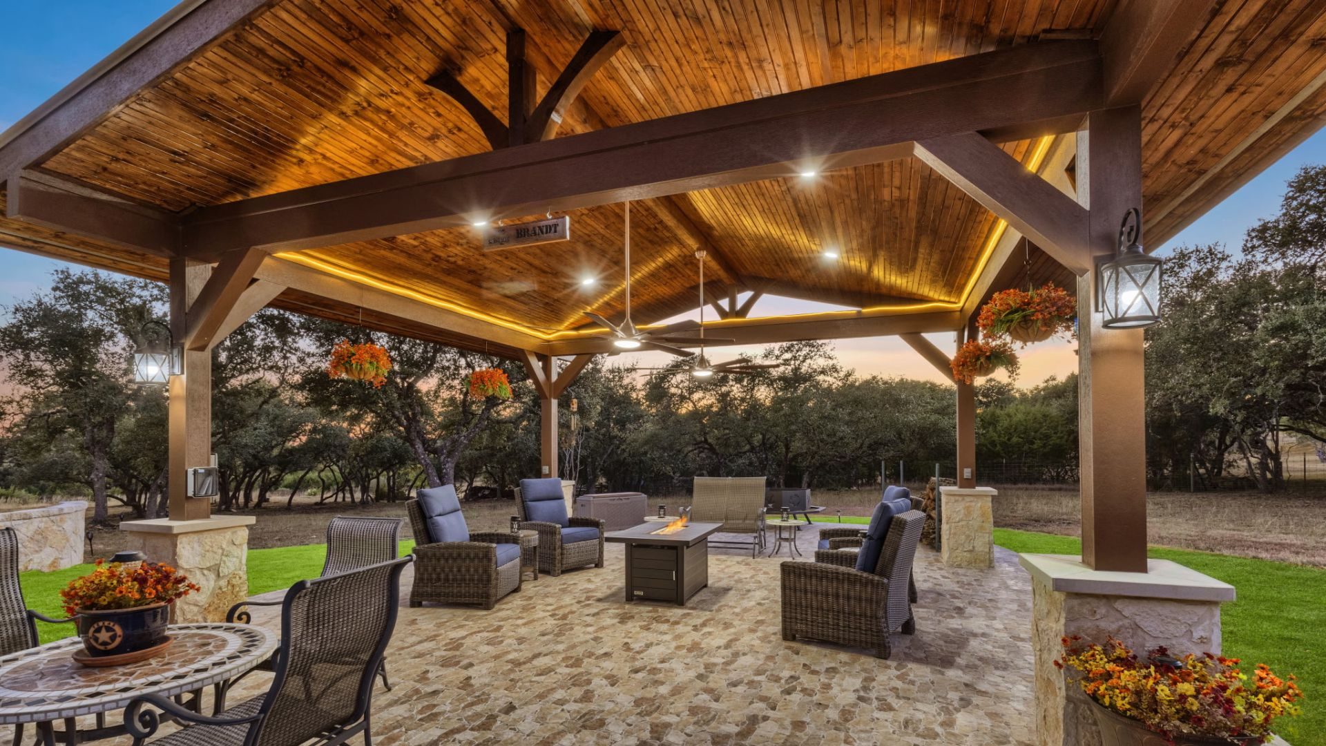 Freestanding cedar pavilion with vaulted wood ceiling and fire pit lounge